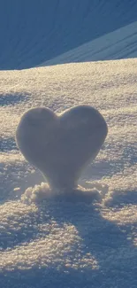 Heart-shaped snow sculpture on light blue textured background.