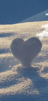 Heart-shaped snow sculpture in soft dawn light on textured snow.