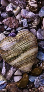 Heart-shaped stone on colorful rock background.