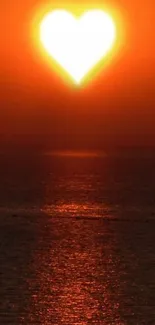 Heart-shaped sunset over ocean, vibrant orange sky.