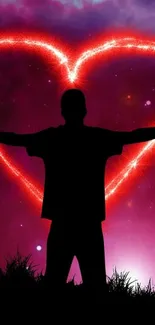 Silhouette with glowing red heart in cosmic background wallpaper.