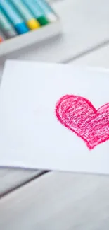 Hand-drawn red crayon heart on white paper.