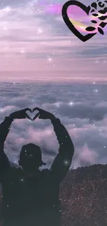 Silhouette with heart shape hands at sunset against a purple cloudy sky.