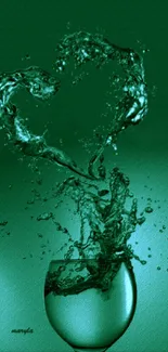 A green heart splash forms from water in a glass.