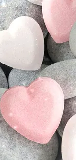 Heart-shaped stones on gray pebbles wallpaper.