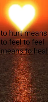 Heart-shaped sunset with an inspirational quote on ocean wallpaper.