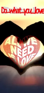 Heart silhouette at sunset with 'All we need is love' text.