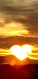 Heart-shaped glowing sunset in a cloudy sky.