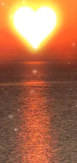 Heart-shaped sunset over ocean with vibrant orange hues.