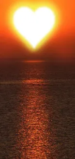 Heart-shaped sun setting over calm ocean waters, casting a warm glow.