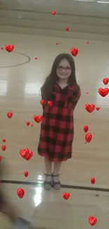 Girl in plaid dress with red hearts on beige background.