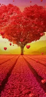 Heart-shaped tree in red field at sunset, showcasing vibrant colors.