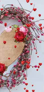 Heart-shaped wreath with roses on light gray background.