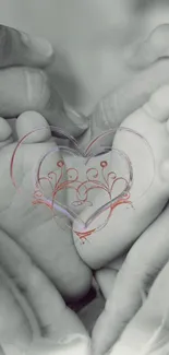 Baby feet held by hands with heart overlay in gray tones.