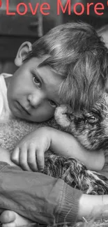 Black and white image of a boy hugging a lamb with a 'Love More' message.