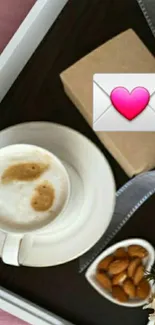 Coffee cup with heart envelope on breakfast tray