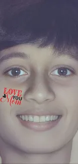 Smiling face with 'Love You Mom' text on cheek.