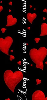 Romantic mobile wallpaper with red hearts and quote on black background.