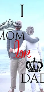 Elderly couple with 'I love mom dad' text on beach.
