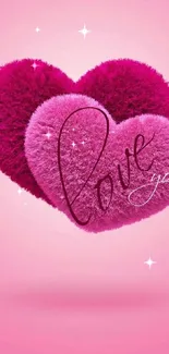 Plush pink hearts with 'Love you' text on a pink background.