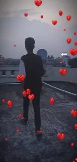 Silhouette on rooftop with red hearts floating in twilight sky.