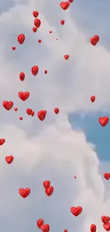 Red heart balloons floating in a light blue sky with fluffy clouds.