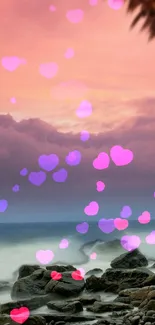 Romantic beach sunset with pink hearts overlaying the ocean.