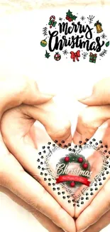 Hands forming heart with Christmas decoration.