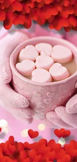 Pink gloves holding a heart-filled mug.