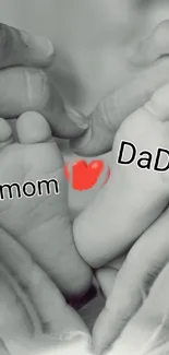 Monochrome heart-shaped family love wallpaper with baby feet and parental hands.