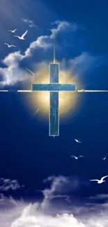 Sunlit cross with flying birds in a blue sky.