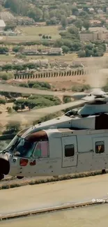 Helicopter flying over green landscape view.