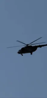 Helicopter flying in the clear blue sky.