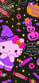 Festive Hello Kitty Halloween wallpaper with candies and spider web.