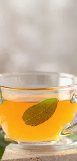 A glass cup of herbal tea with steam rising, on a rustic surface.