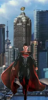 Superhero in black and red cape in front of urban skyline.