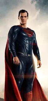 Superhero in blue suit with red cape, standing in a dramatic pose against a cloudy sky.