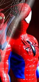 Spider-Man toy in red and blue costume with dark background.