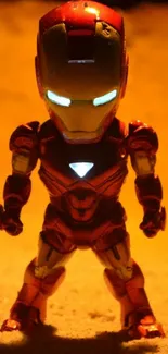 Toy figure resembling hero in desert setting with glowing eyes.