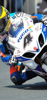 Motorcycle racer leaning into a fast corner during a thrilling race event.