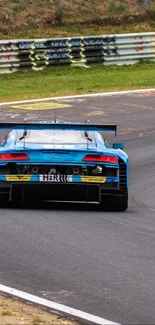 Blue sportscar racing on a track curve.