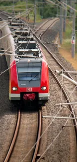 High-speed red train on railway tracks.