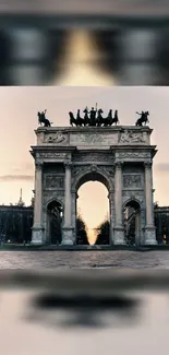 Historic stone archway at sunset with dramatic skies in mobile wallpaper.