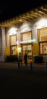 Illuminated historic building at night street.