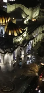 Nighttime view of a historic building facade with glowing lights.