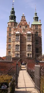 Historic castle with a detailed bridge leading to the entrance.