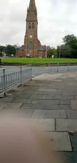 Historic church with a cloudy sky and stone walkway in an urban setting.