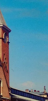 Historic clock tower under a blue sky.