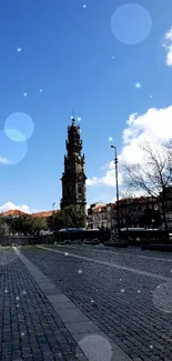 Historic clock tower cityscape under a vibrant blue sky.