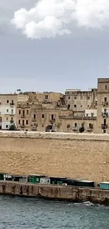 Historic coastal cityscape with ancient stone walls and ocean view.